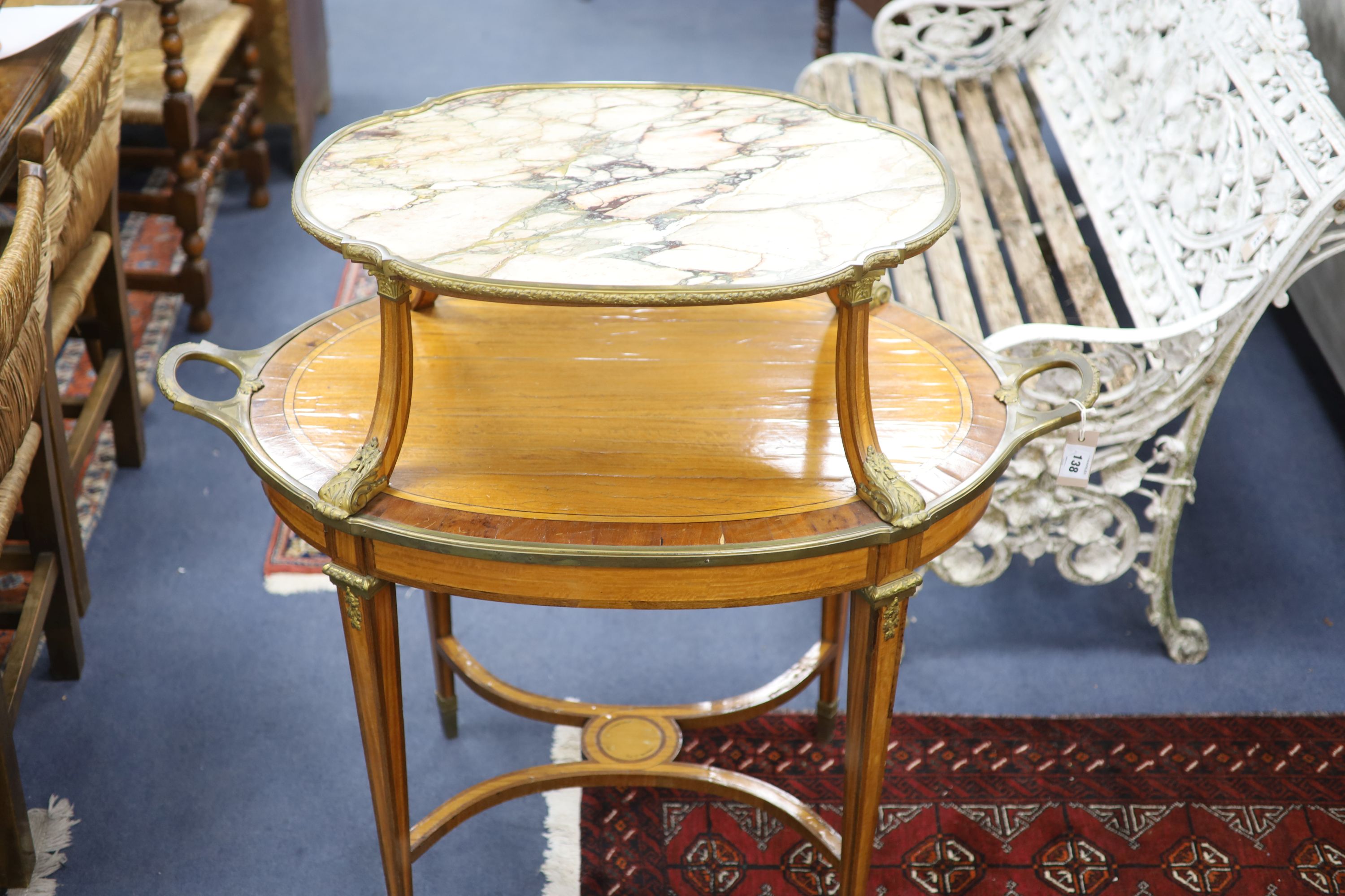 A late 19th century French satinwood, rosewood crossbanded and gilt metal mounted two tier oval etagere,